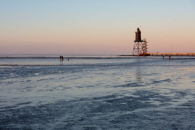 Scenic view of sea against clear sky during sunset