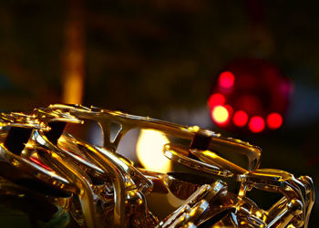 Close-up of an illuminated saxophone at night