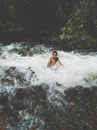 Boy swimming in river