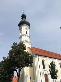 Low angle view of bell tower against sky