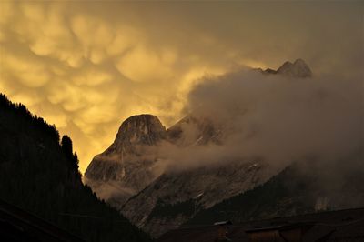 Scenic view of snowcapped mountains against sky during sunset