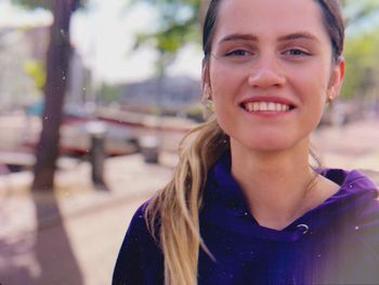 Portrait of smiling young woman in city