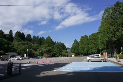 Cars on road against sky