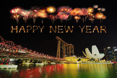 Firework display over river at night