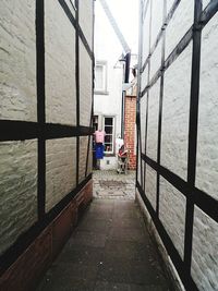 Footpath amidst buildings in city