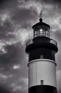 Low angle view of lighthouse against cloudy sky