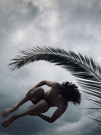 Low angle view of woman against sky