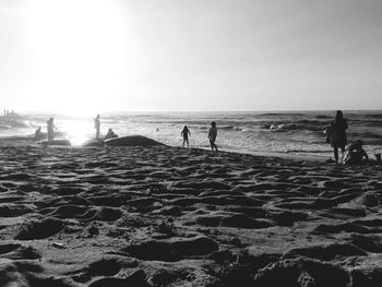 People on beach against sky