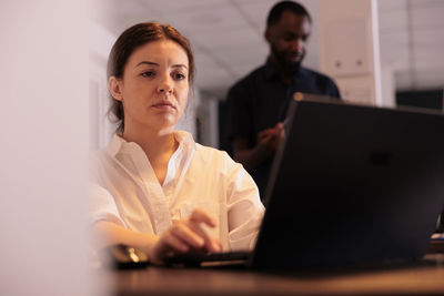 Businesswoman using laptop at office