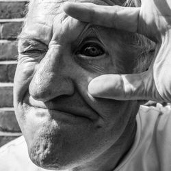 Close-up portrait of senior man with bloodshot eye