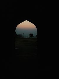 Silhouette of historic building against sky during sunset