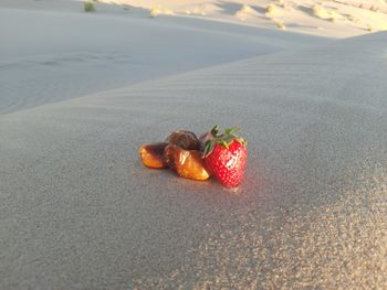 Close-up of cherries on sand