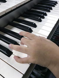 Close-up of hand playing synthesizer