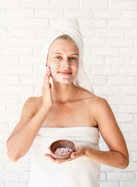 Portrait of a smiling young woman over white background