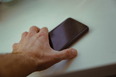 Cropped hands using mobile phone