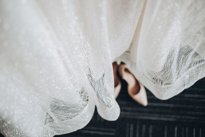 Close-up of woman hand on wet white