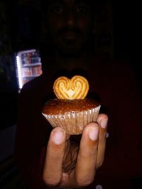 Midsection of person holding cake