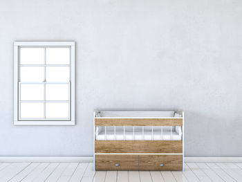 Crib against white wall