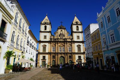 Low angle view of buildings against blue sky