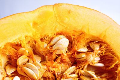 Close-up of orange fruit against white background