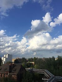 Buildings against cloudy sky