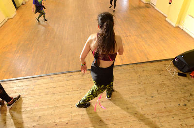 Instructor dancing while exercising at studio