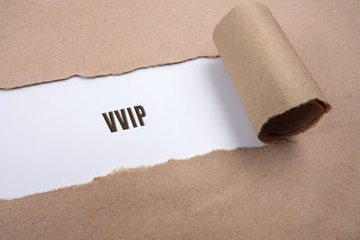 High angle view of torn brown paper with text on white background