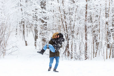 Full length of woman standing on snow covered land