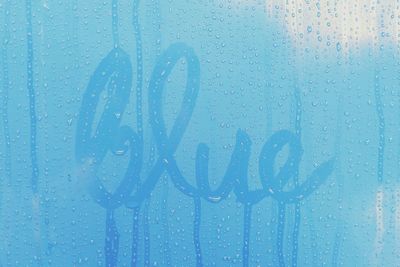 Close-up of blue sky seen through window