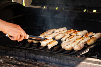 Grilled meat sausages on charcoal grill, outdoor picnic