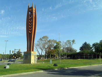 View of tower and trees against blue sky