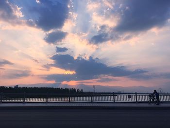 Bridge over river at sunset