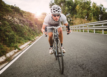 Man riding bicycle on road