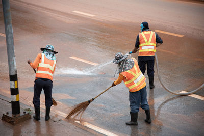 High angle view of workers washing road