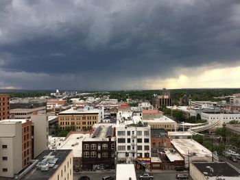 High angle view of cityscape against storm clouds