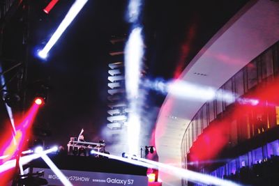 Illuminated railroad station platform at night