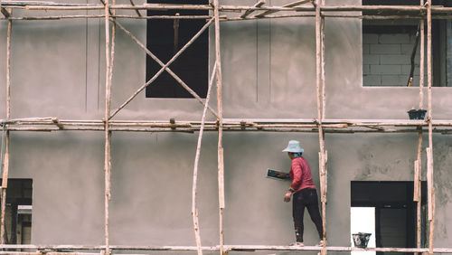 Rear view of worker working at construction site