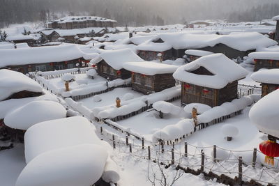 High angle view of snow covered buildings