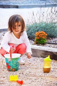 Portrait of cute girl playing with toys at playground