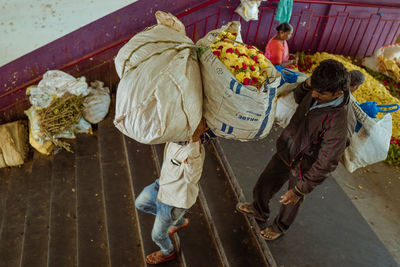 Rear view of people working on street