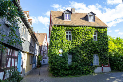 Houses by street and buildings against sky