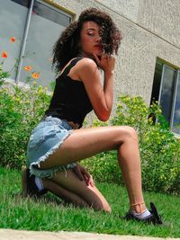 Young woman sitting in grass