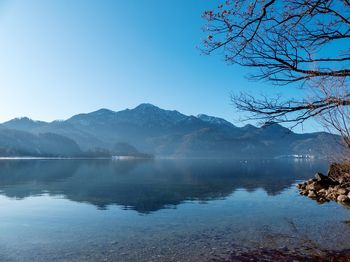 Scenic view of lake and mountains against clear sky