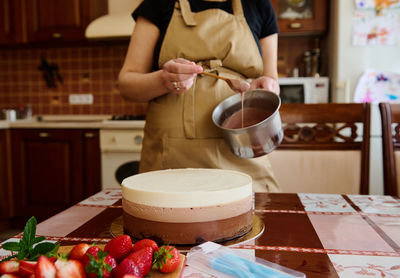 Midsection of woman preparing food on table