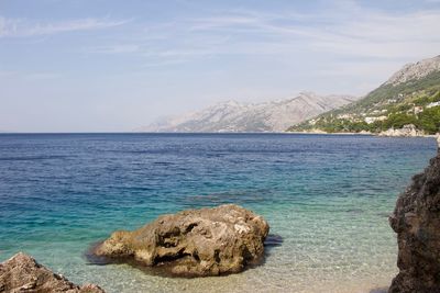 Scenic view of sea and rock formation against sky