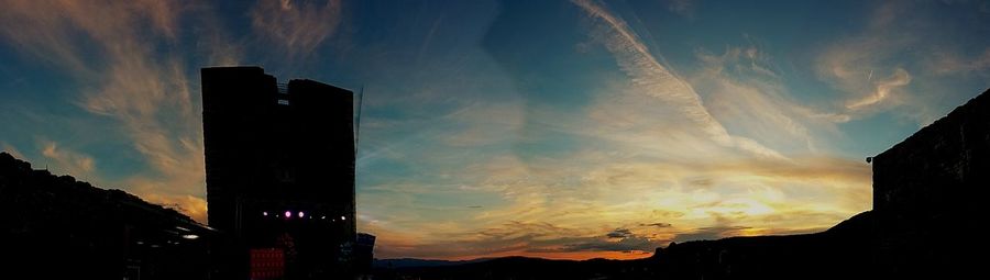 Low angle view of silhouette city against sky during sunset