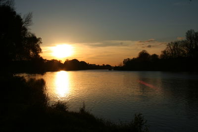 Scenic view of lake at sunset