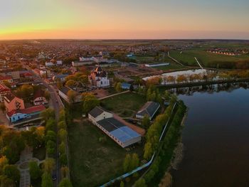 High angle view of houses and buildings against sky during sunset