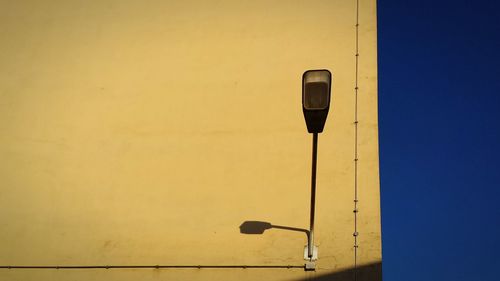 Close-up of yellow lamp against clear sky