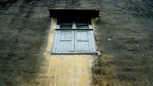 Low angle view of window on old building